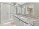 Bathroom featuring double sinks, granite countertops, and a glass shower at 5388 Davini St, Sarasota, FL 34238