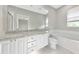 A bright bathroom featuring double sinks, granite countertops, and a soaking tub at 5388 Davini St, Sarasota, FL 34238