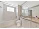 Bathroom with granite vanity, mirror, tub and tiled shower and floors at 5388 Davini St, Sarasota, FL 34238