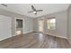 Bedroom with wood floors, ceiling fan, and access to ensuite bathroom at 5388 Davini St, Sarasota, FL 34238