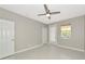 This is a bright bedroom with tile floors, fan and two doors at 5388 Davini St, Sarasota, FL 34238