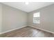 A light and airy bedroom with a window and hardwood floors at 5388 Davini St, Sarasota, FL 34238