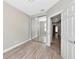 This is a bright bedroom with a mirrored closet, interior door and plank flooring at 5388 Davini St, Sarasota, FL 34238