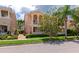 Charming two-story townhome with a quaint balcony, surrounded by mature trees and well-maintained landscaping at 5388 Davini St, Sarasota, FL 34238