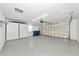 Clean, well-lit garage with ample storage and epoxy flooring, providing a functional and tidy space at 5388 Davini St, Sarasota, FL 34238
