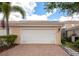 Spacious two-car garage featuring a brick paver driveway, set in a well-kept residential area at 5388 Davini St, Sarasota, FL 34238