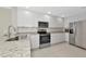 Modern kitchen with white cabinets, stainless steel appliances, and granite countertops at 5388 Davini St, Sarasota, FL 34238