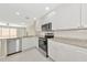 Modern kitchen with white cabinets, stainless appliances and breakfast bar at 5388 Davini St, Sarasota, FL 34238