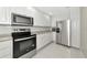Modern kitchen features stainless appliances, white cabinets and tile floors at 5388 Davini St, Sarasota, FL 34238
