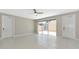 Bright, open living space with neutral tones, featuring tile flooring and sliding glass doors at 5388 Davini St, Sarasota, FL 34238