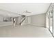 Open-concept living space with light tile, stairs, and access to the outdoors at 5388 Davini St, Sarasota, FL 34238