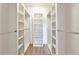 A walk-in closet with white shelves and plenty of storage space at 5388 Davini St, Sarasota, FL 34238