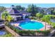 Aerial view of the community pool with lounge seating, surrounded by lush landscaping at 5531 Rosehill Rd # 204, Sarasota, FL 34233