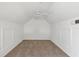Neutral attic space with clean white paint and carpet throughout at 5531 Rosehill Rd # 204, Sarasota, FL 34233