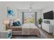 Well-lit bedroom featuring a ceiling fan, neutral colors, and window views to the outside at 5531 Rosehill Rd # 204, Sarasota, FL 34233