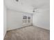 Carpeted bedroom with a ceiling fan, view to the outside, and neutral paint colors at 5531 Rosehill Rd # 204, Sarasota, FL 34233