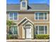 Charming townhome featuring classic architecture, a welcoming entrance, and lovely landscaping at 5531 Rosehill Rd # 204, Sarasota, FL 34233