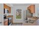 Traditional kitchen featuring stainless steel appliances, a window view, and tile floors at 5531 Rosehill Rd # 204, Sarasota, FL 34233