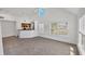Bright, open living area with a kitchen featuring a breakfast bar, a large window and high ceilings at 5531 Rosehill Rd # 204, Sarasota, FL 34233