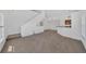 Open-concept living area flows into the kitchen, featuring high ceilings and neutral carpet at 5531 Rosehill Rd # 204, Sarasota, FL 34233