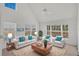 Bright living room featuring high ceilings, neutral décor, and plenty of natural light at 5531 Rosehill Rd # 204, Sarasota, FL 34233