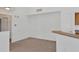 Spacious living room with neutral carpet, bright white walls, and a convenient breakfast bar at 5531 Rosehill Rd # 204, Sarasota, FL 34233