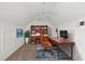 Bright office features a large bookshelf and desk, and a ceiling fan for a comfortable work environment at 5531 Rosehill Rd # 204, Sarasota, FL 34233
