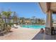 Community swimming pool with lounge chairs and lush landscaping at 5531 Rosehill Rd # 204, Sarasota, FL 34233