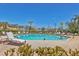 Community swimming pool with lounge chairs and lush landscaping at 5531 Rosehill Rd # 204, Sarasota, FL 34233