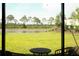 Scenic view of the backyard with a tranquil pond, as seen from the screened-in patio at 5684 Blue Reef Place, Nokomis, FL 34275