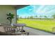 Picturesque backyard view from the screened patio, showcasing the lush greenery and serene pond at 5684 Blue Reef Place, Nokomis, FL 34275