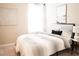 This spacious bedroom features a comfortable bed, soft carpet, and is decorated in neutral colors with artwork at 5684 Blue Reef Place, Nokomis, FL 34275
