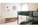 This is a cozy bedroom with a bunkbed, dresser, and decorated with neutral colors with modern art at 5684 Blue Reef Place, Nokomis, FL 34275