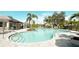 Inviting community pool area featuring ample lounge seating, shade, and a shallow entry at 5684 Blue Reef Place, Nokomis, FL 34275