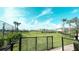 Fenced community dog park with lush greenery, providing a safe and fun area for pets at 5684 Blue Reef Place, Nokomis, FL 34275