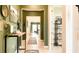Inviting hallway with stylish decor leading to a bright and airy living space at 5684 Blue Reef Place, Nokomis, FL 34275