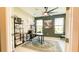 Home office featuring neutral colors, modern shelving, a large desk, with natural light from the windows at 5684 Blue Reef Place, Nokomis, FL 34275