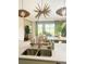 Modern kitchen island featuring a double sink, stylish fixtures, and an open view of the living area at 5684 Blue Reef Place, Nokomis, FL 34275