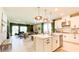 Open-concept design connects a modern island kitchen to the living and dining areas at 5684 Blue Reef Place, Nokomis, FL 34275