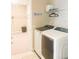 Convenient laundry room featuring modern washer and dryer units and ample shelving space at 5684 Blue Reef Place, Nokomis, FL 34275
