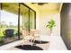 Relaxing screened patio with comfortable seating and view of the lush landscaping at 5684 Blue Reef Place, Nokomis, FL 34275