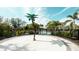 Community splash pad with palm tree water feature and nearby pool at 5684 Blue Reef Place, Nokomis, FL 34275