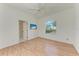 Bedroom featuring hardwood floors, a ceiling fan, and an arched window at 585 Khyber Ln, Venice, FL 34293