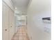 Hallway view shows kitchen, closet, and entry point to the house at 585 Khyber Ln, Venice, FL 34293