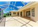 Large screened lanai with a tile floor, with sliding doors to the interior at 585 Khyber Ln, Venice, FL 34293