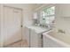Functional laundry area with washer, dryer, utility sink and ample storage cabinets for a tidy space at 585 Khyber Ln, Venice, FL 34293