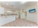 Bright, open-concept living area with a bar and kitchen, plus a flat screen TV on the wall at 585 Khyber Ln, Venice, FL 34293