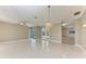 Open floor plan with white tile, chandelier, and views of the pool and adjacent living spaces at 585 Khyber Ln, Venice, FL 34293