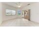 Bright living room features tile floors, ceiling fan, and sliding glass doors at 585 Khyber Ln, Venice, FL 34293
