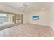 Relaxing room offering tile flooring, access to the lanai, and a wall-mounted TV at 585 Khyber Ln, Venice, FL 34293